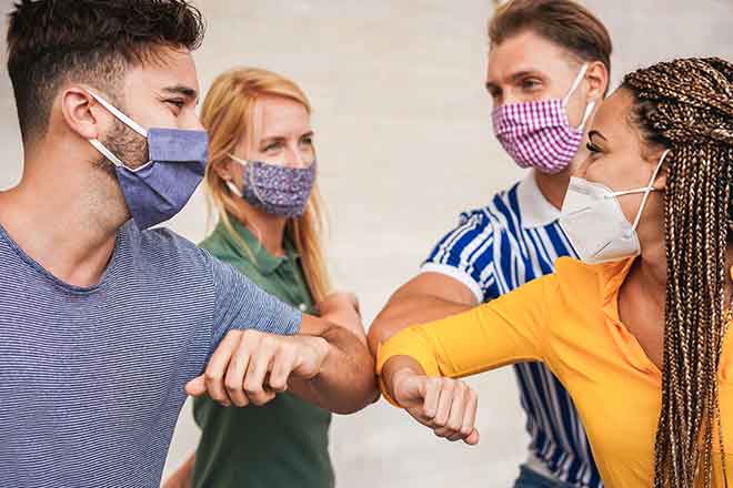 PROMO 64J1 Health - Mask People Elbow Bump - iStock - DisobeyArt