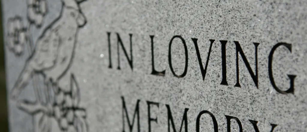 Grave marker inscribed with 'In Loving Memory' - iStock - melissarobison Grave marker inscribed with 'In Loving Memory' - iStock - melissarobison