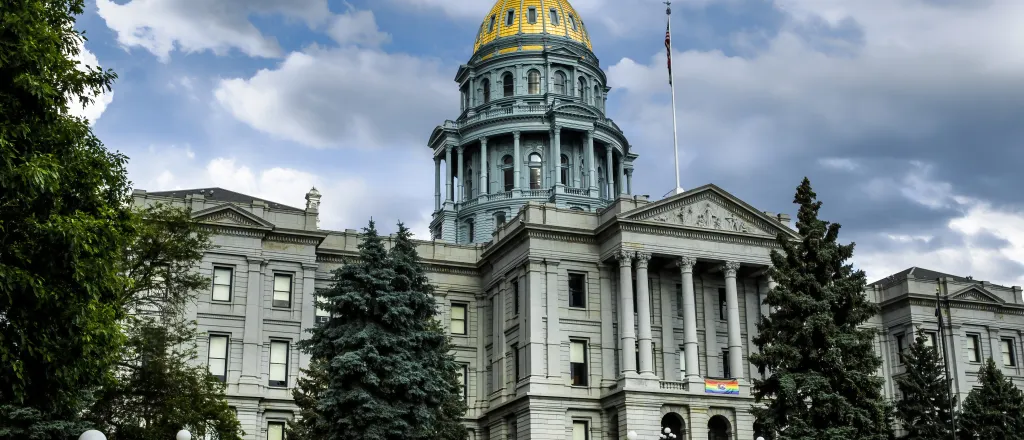 Colorado State Capitol Building Colorado State Capitol Building fronted by green trees under a cloudy sky