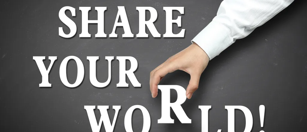 Words "share your world!" on a grey background with a hand picking up the letter 'r' in world