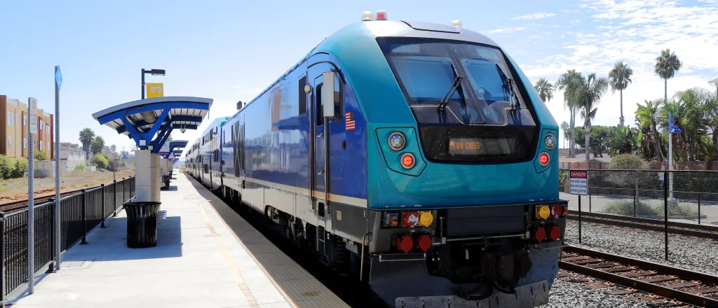 Light rail passenger train stopped at a station platform