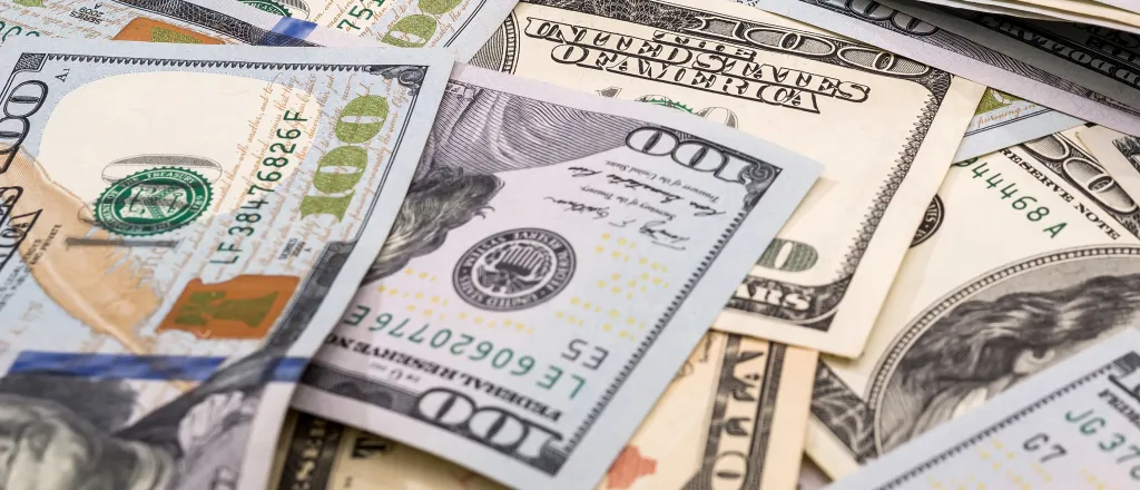 PROMO HIRES Finance - Money Cash Bills Gavel Justice - iStock - alfexe United States $100 bills randomly laid out in a pile.