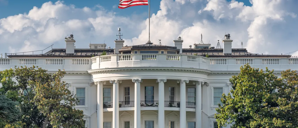 Front of the White House in Washington DC with the flag of the United States flying above