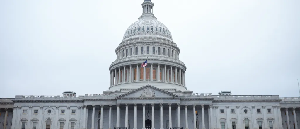 View of the west front door of the United States capitol building under cloudy skies