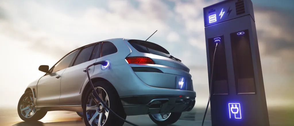 Electric car at a charging station with clouds in the background