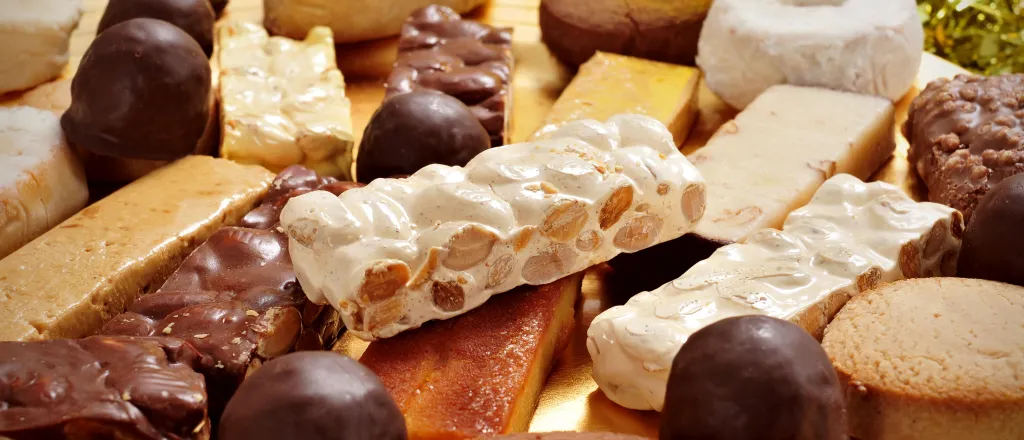 Stacks of assorted chocolates and other sweet confectioneries.