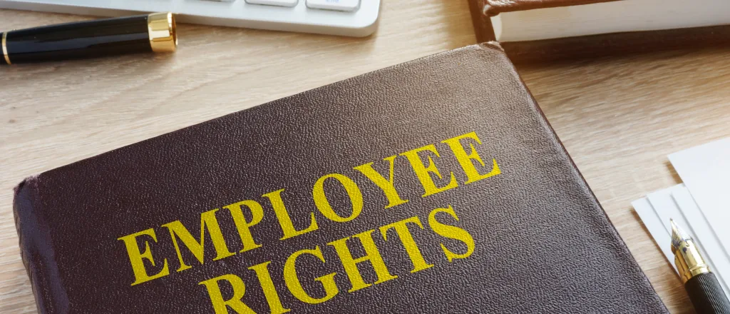 PROMO HIRES Business - Labor Union Employee Rights Job Desk Keyboard Pen - designer491 - iStock-931431806 Book titled "Employee Rights" on a desk near pens, a computer keyboard, and another book