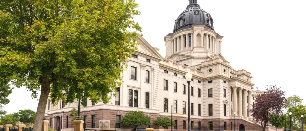 View of the front of the South Dakota State Capitol Building from an angle.