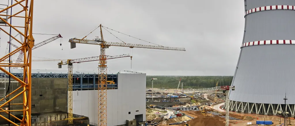 PROMO HIRES CROPPED Energy - Nuclear Power Plant Construction - Vital Hil - iStock-1461437060 Construction cranes around a nuclear power plant and cooling tower