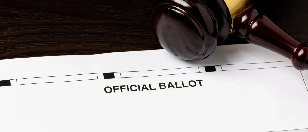PROMO HIRES Election - Ballot Court Vote Politics Government Law - JJ Gouin - iStock-2074087177 Court judge's gavel resting on an election ballot.