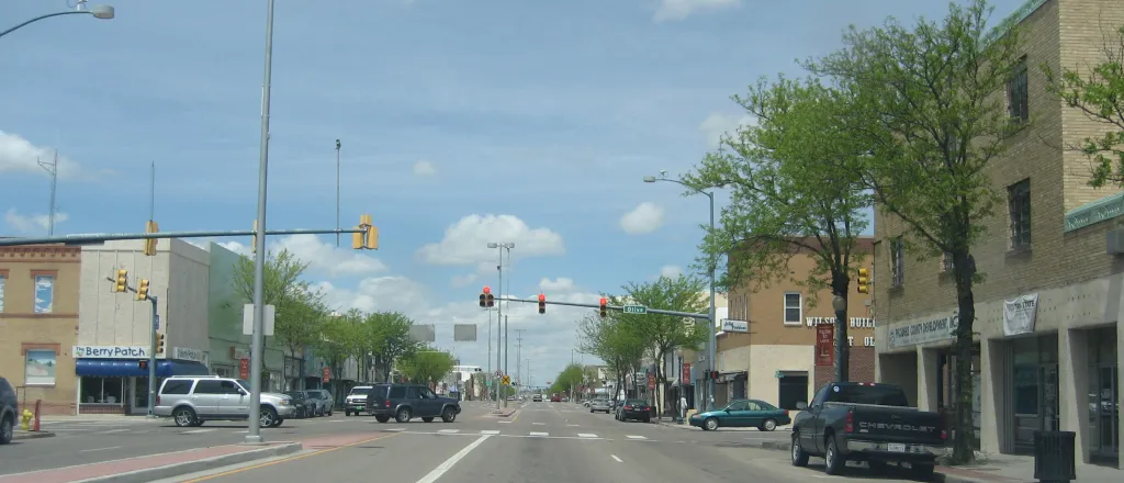 Street scene showing commercial buildings and traffic.
