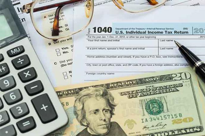 PROMO 660 x 440 Money - Tax Form Calculator Money Glasses - iStock PROMO 660 x 440 Money - Tax Form Calculator Money Glasses - iStock