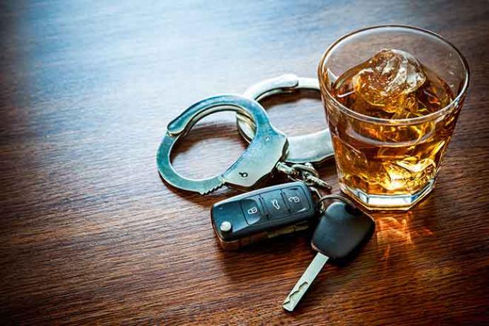 64J Crime - Drink Drive Whiskey Alcohol Key Fob Handcuff Table Glass - iStock - AlexRaths Crime - Drink Drive Whiskey Alcohol Key Fob Handcuff Table Glass - iStock - AlexRaths