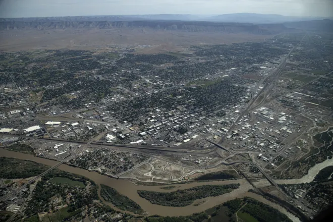 PICT The Colorado River flows through Grand Junction, June 9, 2023. The railroad is visible coming into the city from the left along the river then turning abruptly east. William Woody for Colorado Newsline