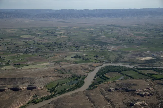 PICT The Colorado River flows through the Grand Valley near Loma on June 9, 2023. The railroad is visible running across the middle of the frame. William Woody for Colorado Newsline