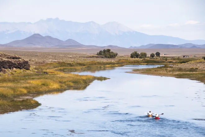 Two people kayaking on the Rio Grand river in Colorado.