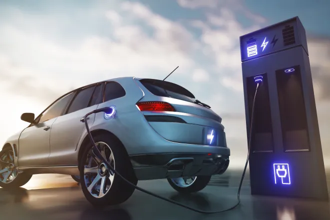 Electric car at a charging station with clouds in the background