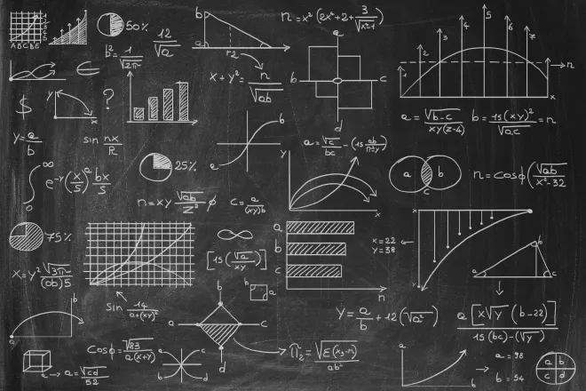 Chalk board with formulas, graphs, and charts.