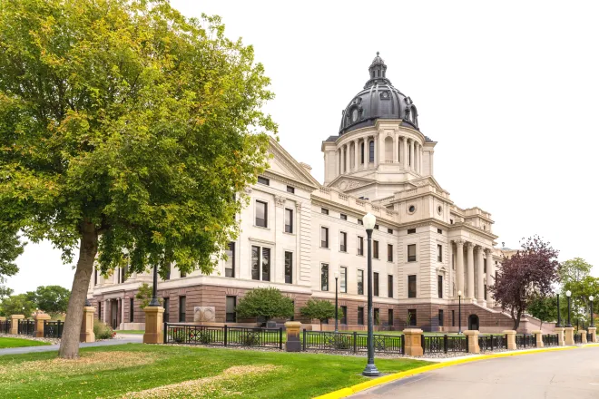 View of the front of the South Dakota State Capitol Building from an angle.