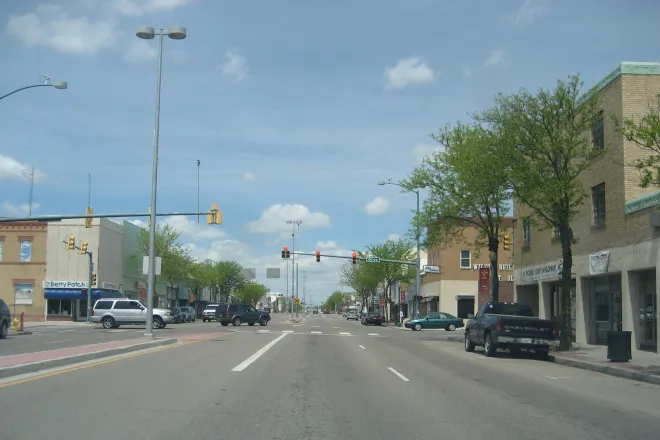 Street scene showing commercial buildings and traffic.