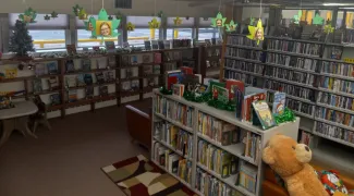 Interior of the Kiowa County Public Library showing shelves of books and decorations.