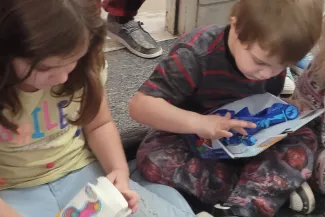 Children unwrapping gifts.