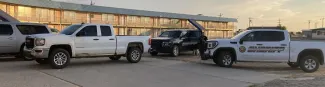 Kiowa County Sheriff's Office vehicles surrounding a pickup in front of a motel.