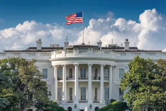 Front of the White House in Washington DC with the flag of the United States flying above