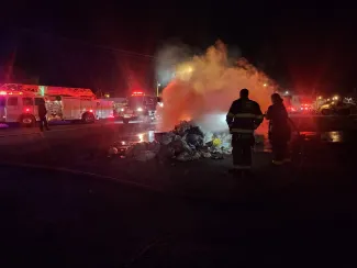 Pile of burning trash emptied from a sanitation truck