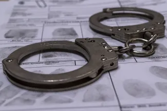 Close up of hand cuffs on a fingerprint card