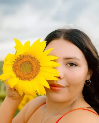 Emily Melgoza Emily Melgoza holding a sunflower