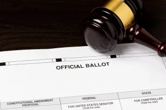 PROMO HIRES Election - Ballot Court Vote Politics Government Law - JJ Gouin - iStock-2074087177 Court judge's gavel resting on an election ballot.