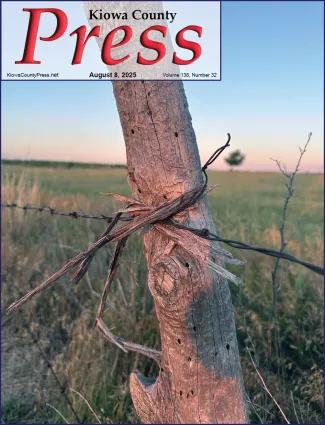 Photo of the week from the August 8, 2025, edition of the Kiowa County Press in Eads, Colorado -  Weathered fence post and barbed wire in Kiowa County, Colorado - Chris Sorensen.