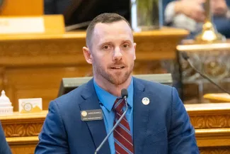 PROMO HIRES CROPPED Politician - Colorado State Representative Jarvis Caldwell - public domain Colorado State Representative Jarvis Caldwell speaking on the floor of the Colorado state capitol.