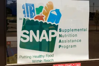 Photo of a sign the Supplemental Nutrition Assistance Program (SNAP) in a store window.