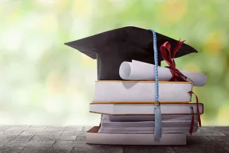 PROMO Education - Graduation Cap Diploma Books - iStock - leolintang