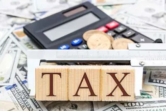 PROMO 64J1 Government - Taxes Money Calculator Word Blocks - iStock - LIgorko PROMO Government - Taxes Money Calculator Word Blocks - iStock - LIgorko
