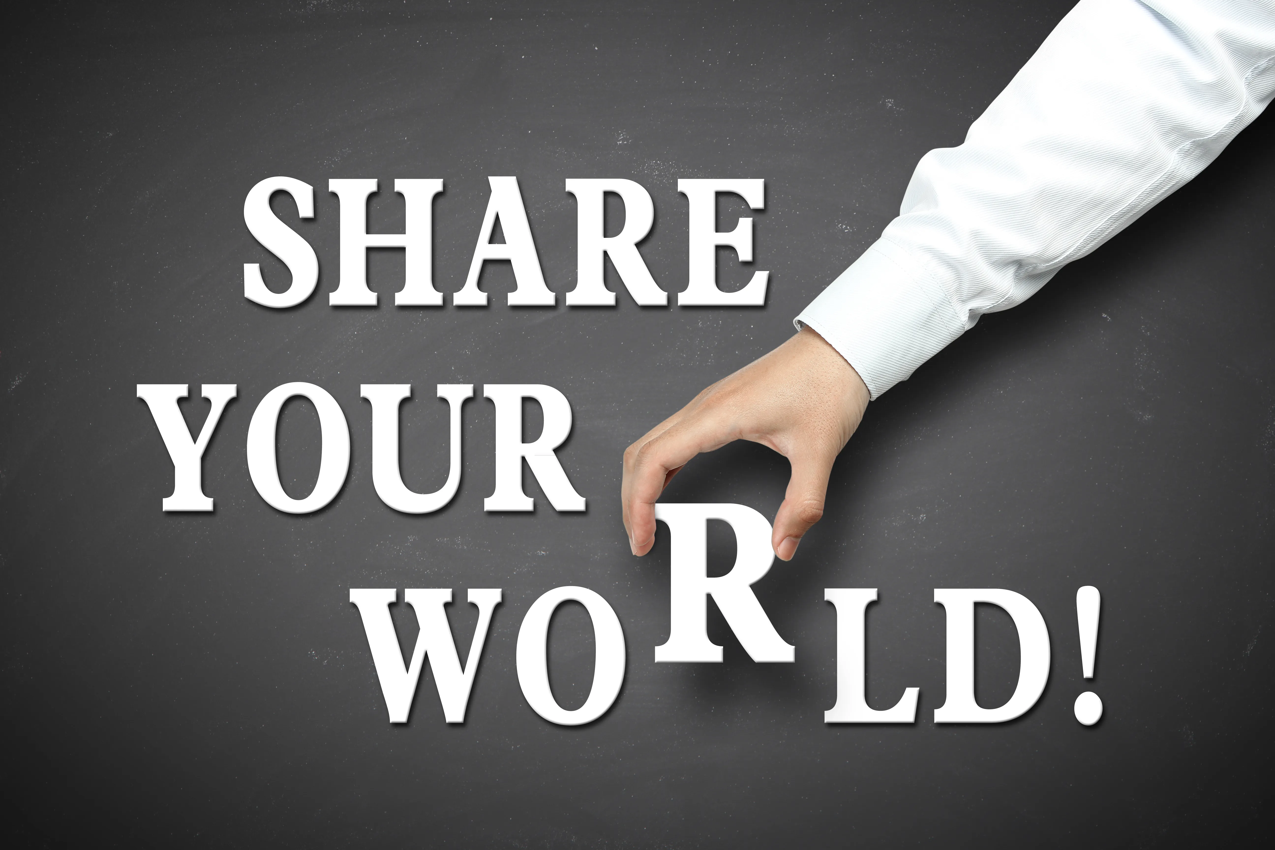 Words "share your world!" on a grey background with a hand picking up the letter 'r' in world