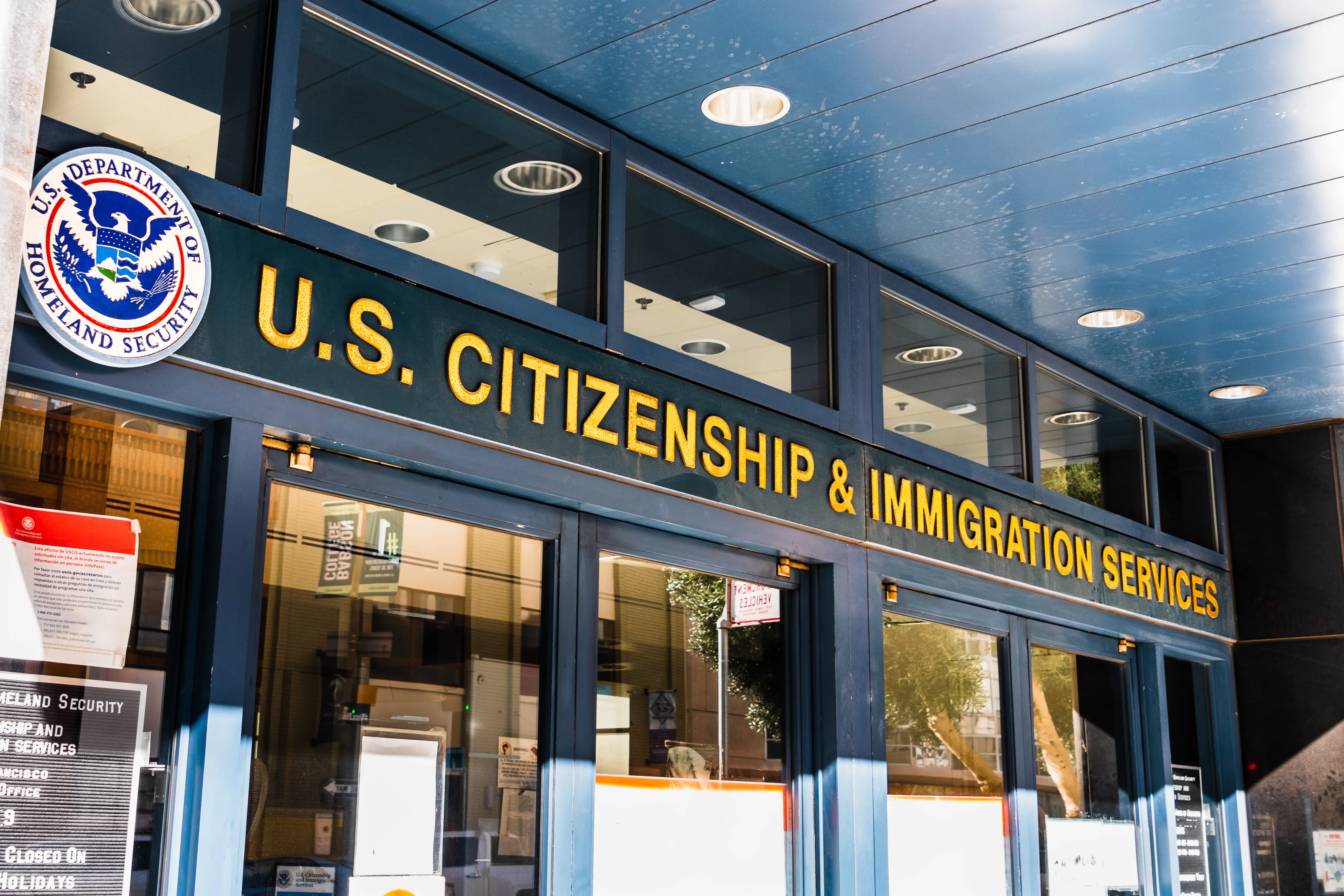 Doors to a building below a sign reading "US Citizenship and Immigration Services"