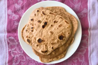 Plate of chapatis flatbread on a cloth.