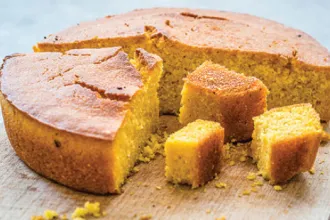 Round lemon corn cake, sliced, with various sized pieces.