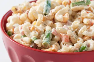 Bowl of macaroni and vegetable salad.