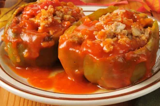 Plate with two halves of stuffed green peppers.