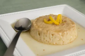 Flan on a plate with a spoon.