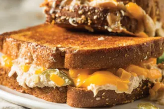 Close up of a tuna melt burger on a plate.