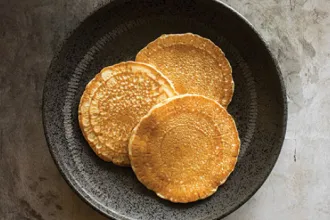 Overhead photo of a plate with three whole wheat pancakes