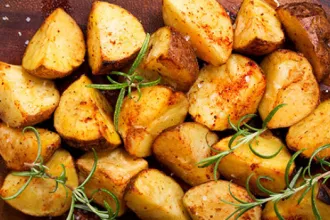 Herb Roasted Potatoes - USDA Herb roasted potatoes with sprigs of rosemary
