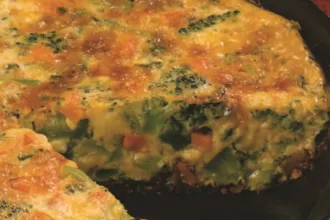 Close up view of a Broccoli-Cheddar Frittata with a slice removed